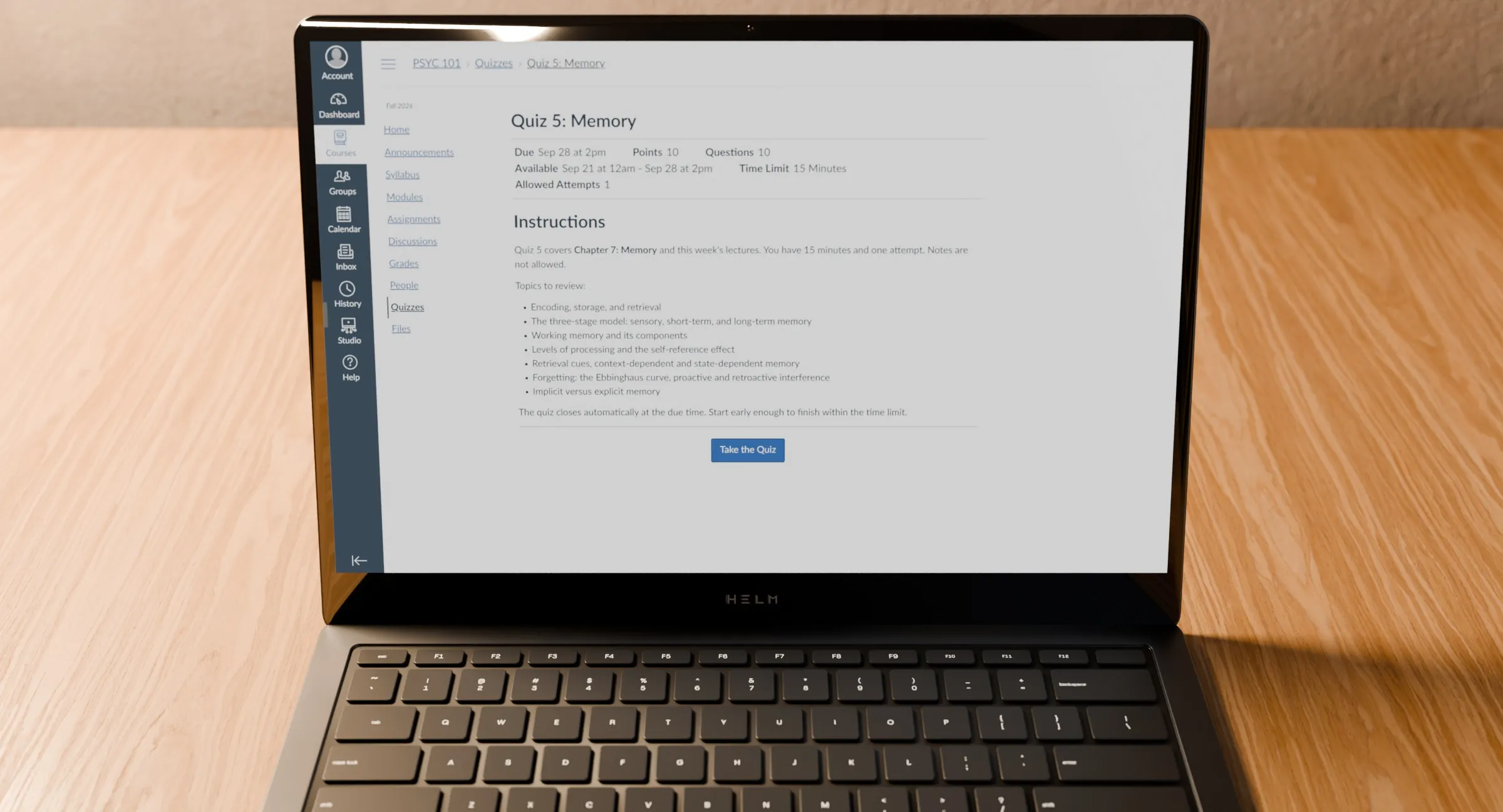 An open laptop on a desk at night, showing a Canvas quiz page.